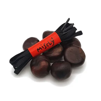 A bundle of flat black laces resting on a pile of conkers.
